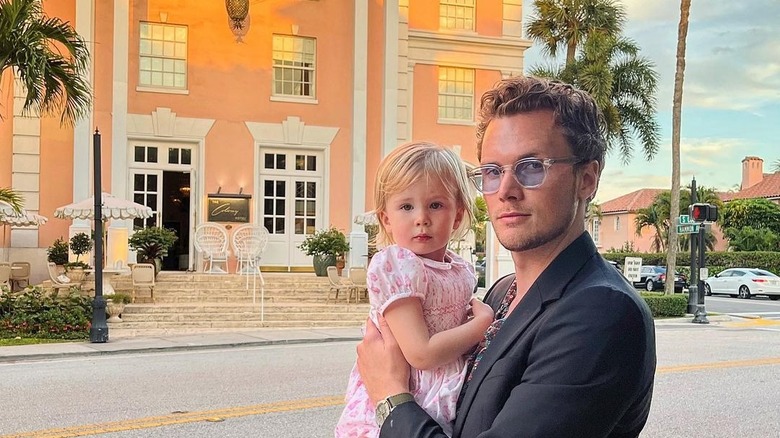 Barron Hilton and daughter look at camera