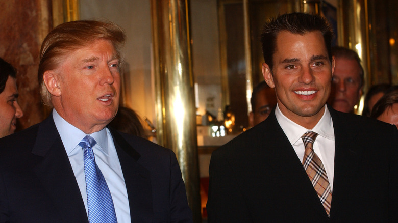 Donald Trump speaking and Bill Rancic smiling