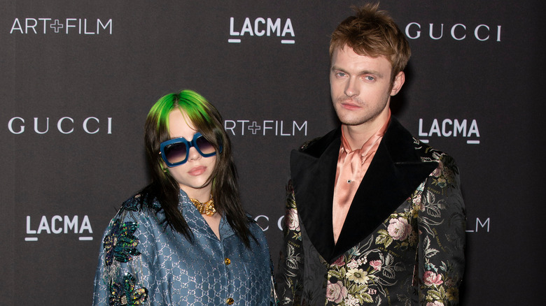 Billie Eilish and Finneas posing on the red carpet