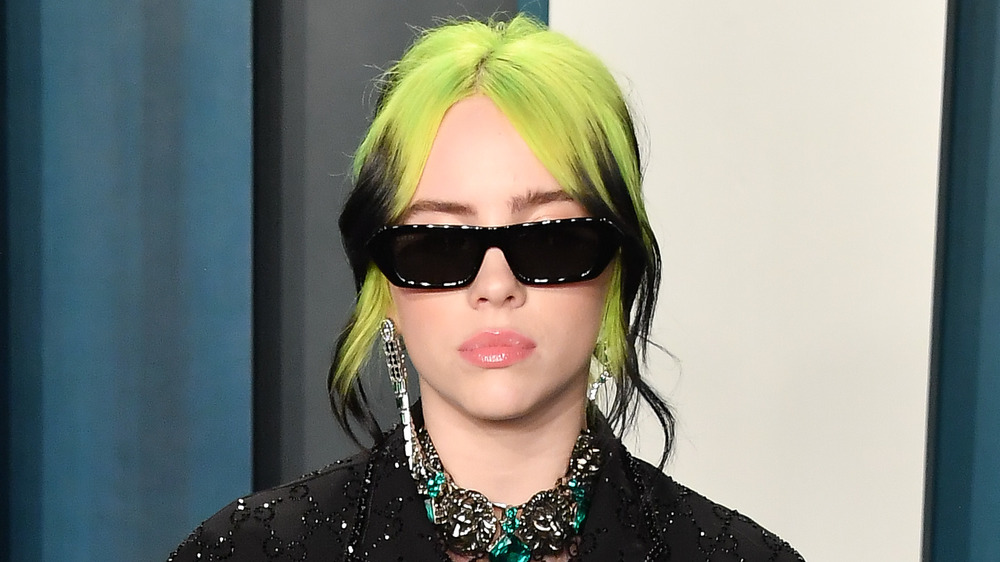 Billie Eilish wearing dark sunglasses and an updo