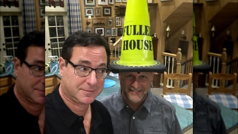 Bob Saget with Dave Coulier wearing a cone on his head