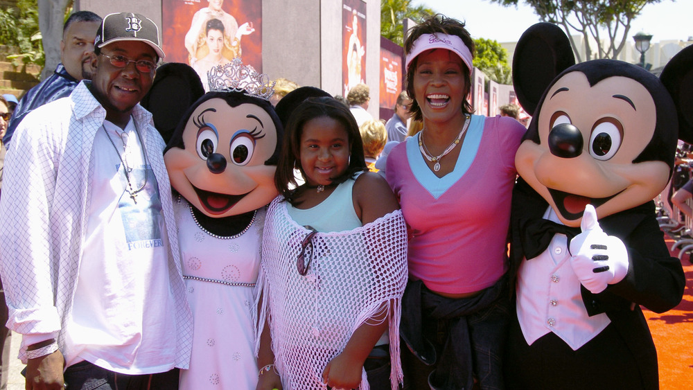 Bobby Brown, Bobbi Kristina Brown, and Whitney Houston enjoying Disney Land