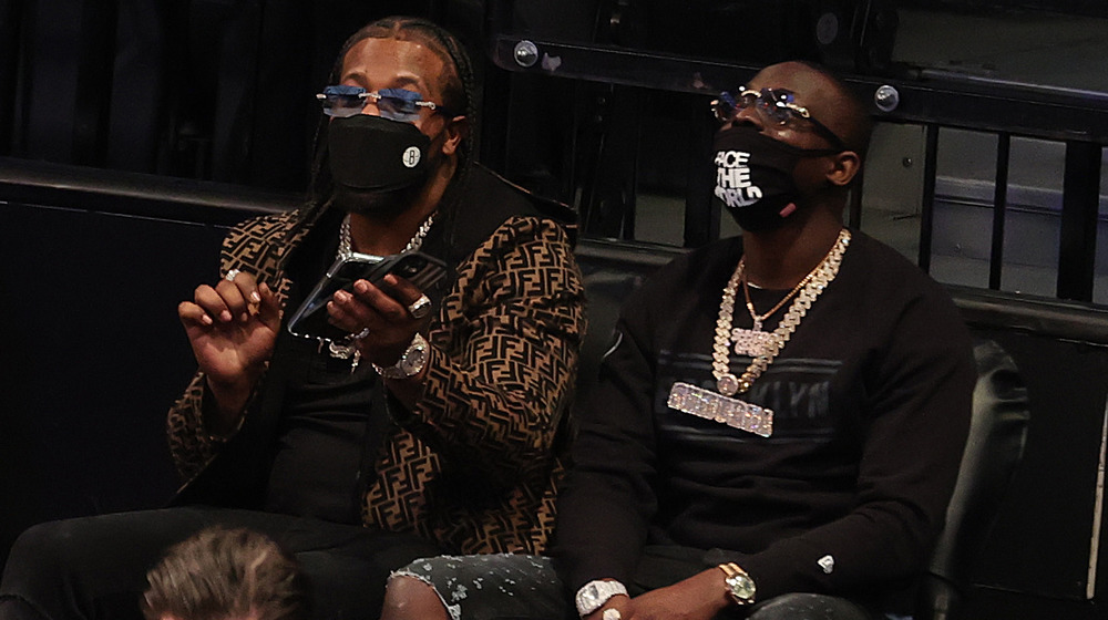 Rowdy Rebel and Bobby Shmurda at a Brooklyn Nets game