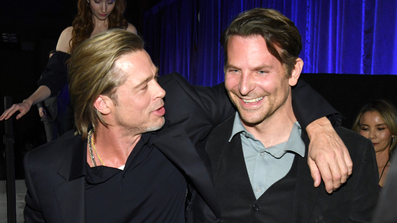 Brad Pitt and Bradley Cooper hug and laugh