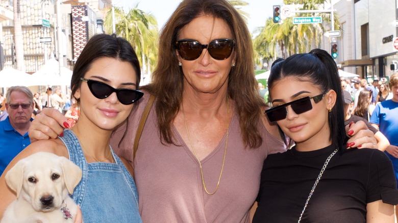 Caitlyn Jenner embraces Kendall (with dog) and Kylie