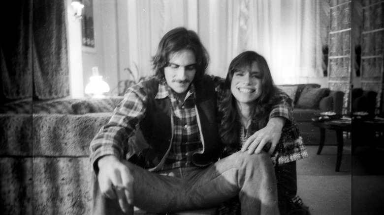 Young James Taylor and Carly Simon sitting together