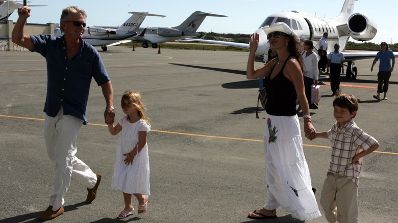 Michael Douglas and Catherine Zeta-Jones holding kids' hands