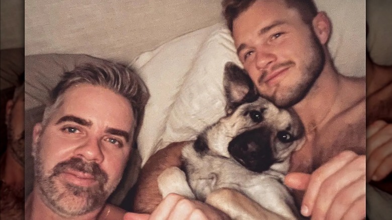 Jordan C. Brown and Colton Underwood posing with their dog