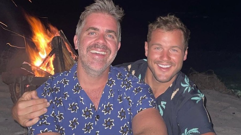 Jordan C. Brown and Colton Underwood smiling in front of bonfire