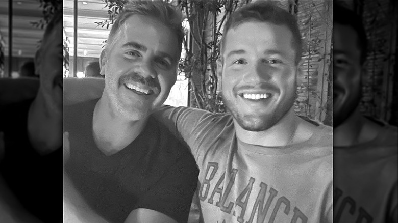 Colton Underwood and Jordan C. Brown smiling, black and white photo