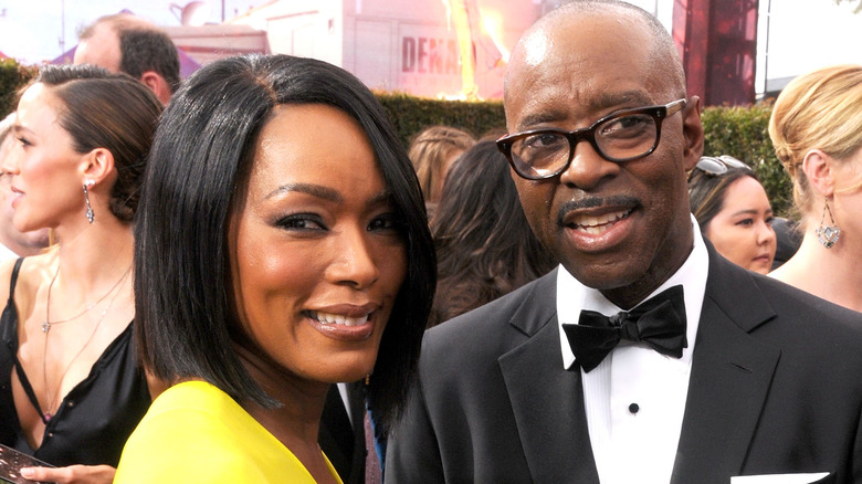 Angela Bassett and Courtney B. Vance smiling on the red carpet 