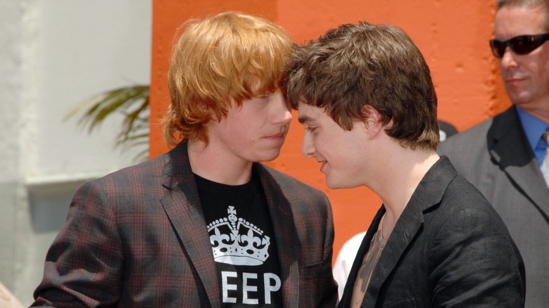 Rupert Grint and Daniel Radcliffe talk during an event