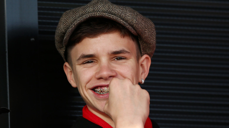 Romeo Beckham grinning 