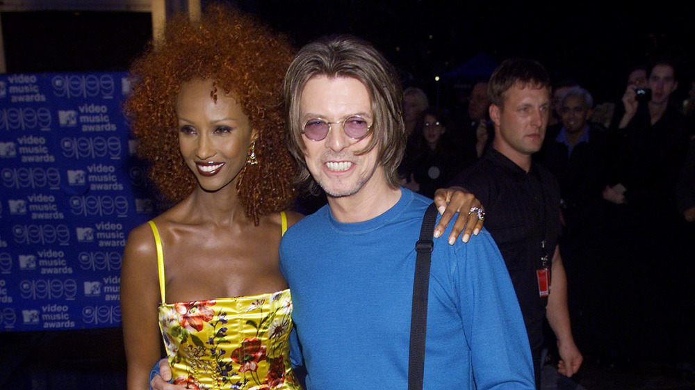 David Bowie and Iman smiling, arm in arm