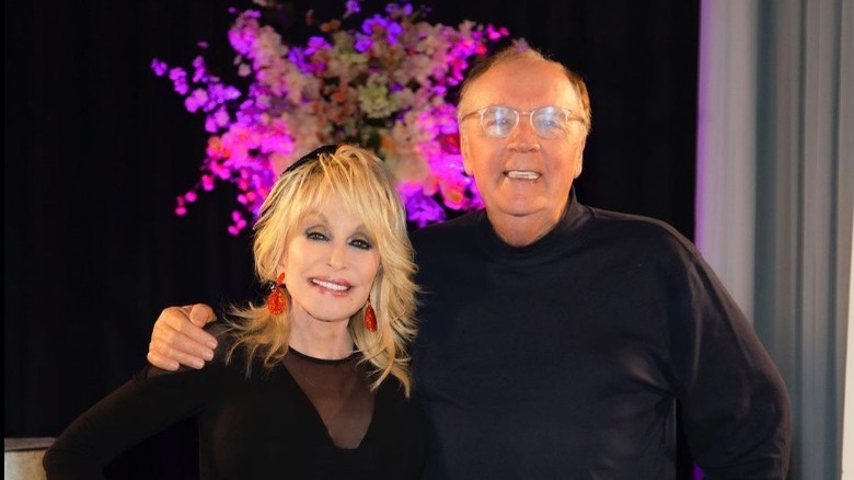 Dolly Parton and James Patterson smile for a photo