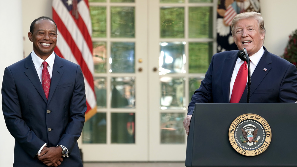 Tiger Woods smiles as President Trump presents him with the Presidential Medal of Freedom