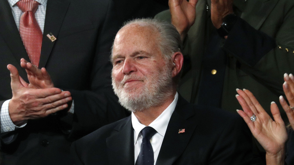 Rush Limbaugh smiling as people clap