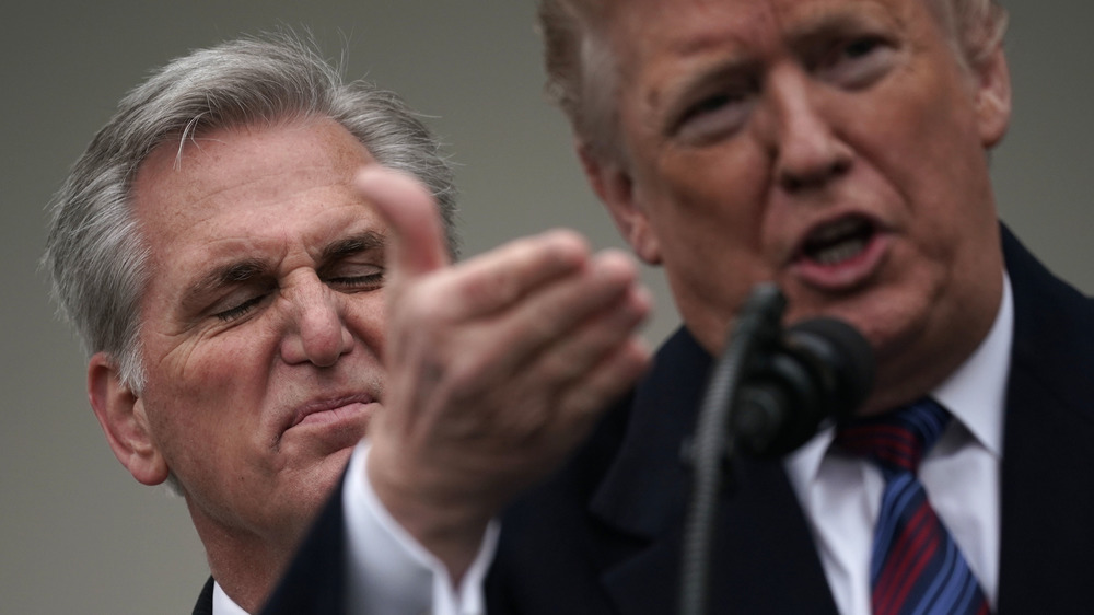 Kevin McCarthy sneering behind Trump