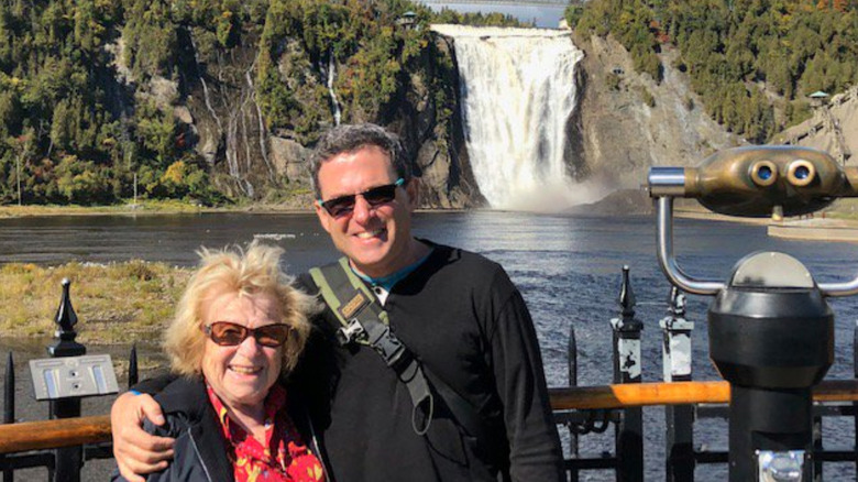 Dr. Ruth Westheimer and Dr. Joel Westheimer in front of waterfall