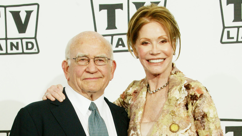 Ed Asner and Mary Tyler Moore smiling on the red carpet