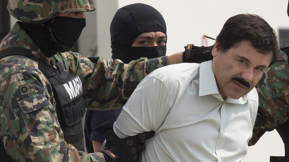 El Chapo taken through Mexican International Airport after his arrest, February 2014