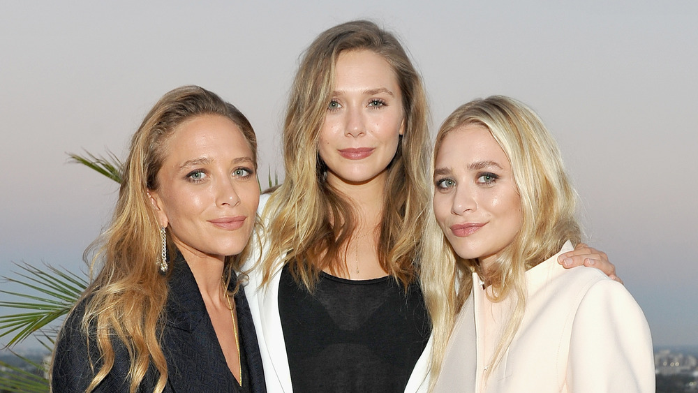 Mary-Kate Olsen, Elizabeth Olsen, and Ashley Olsen posing together