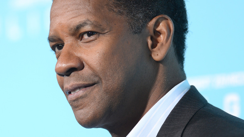 Denzel Washington smirking in side profile