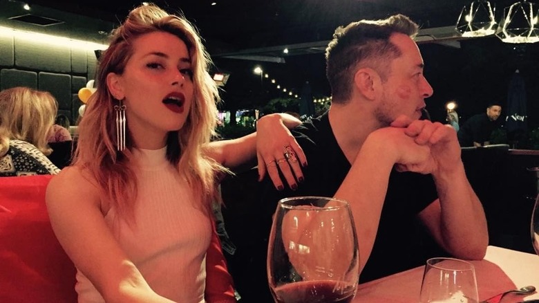 Amber Heard sitting with Elon Musk in a restaurant