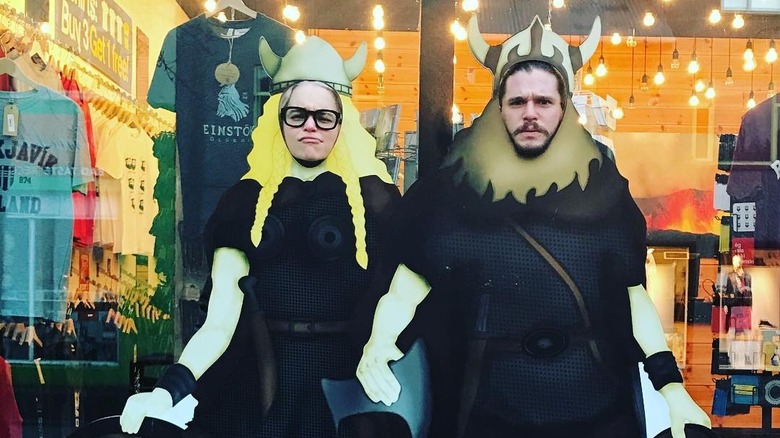 Emilia Clarke and Kit Harington pose in face-hole board of vikings