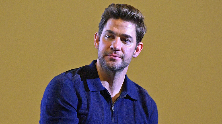 John Krasinski smiles and tilts head