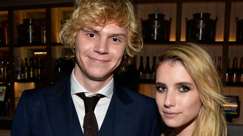 Evan Peters, Emma Roberts, both smiling