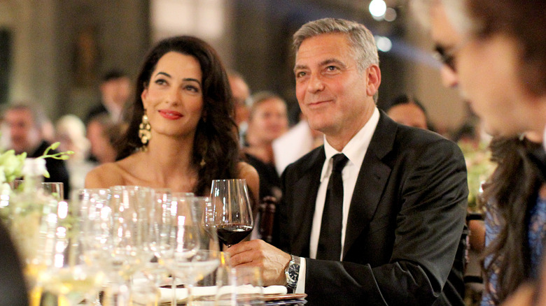 Amal Clooney and George Clooney at an event