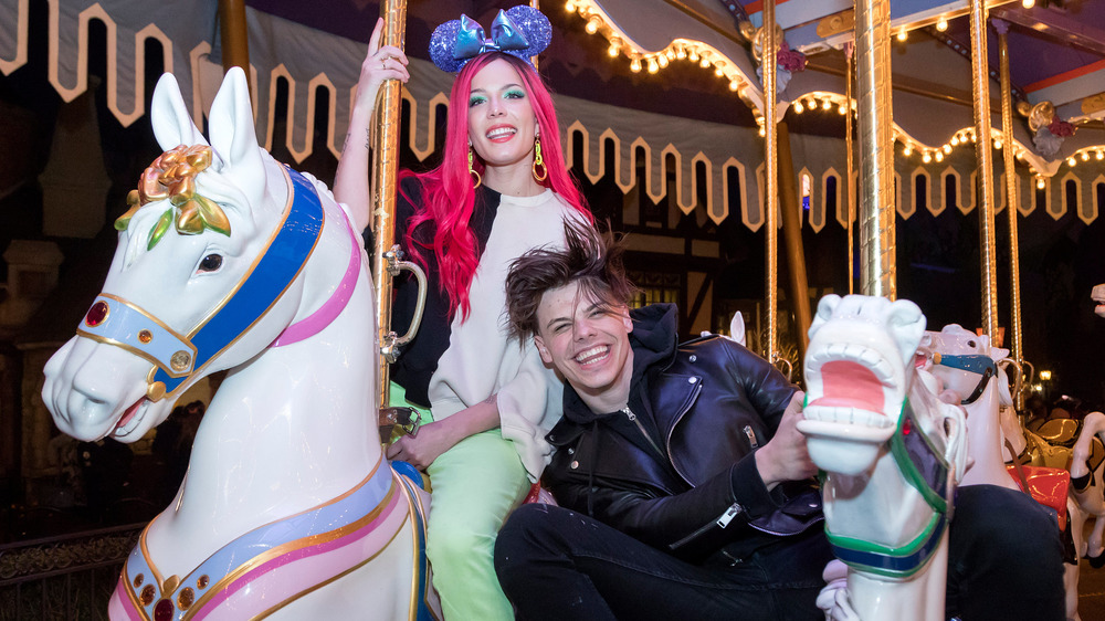 Halsey and Yungblud laughing on a carousel 
