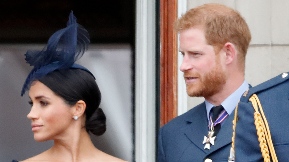 Meghan Markle and Prince Harry looking to the side