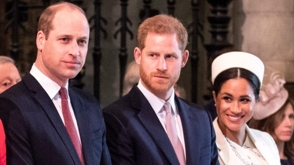 Prince William, Prince Harry, and Meghan Markle standing