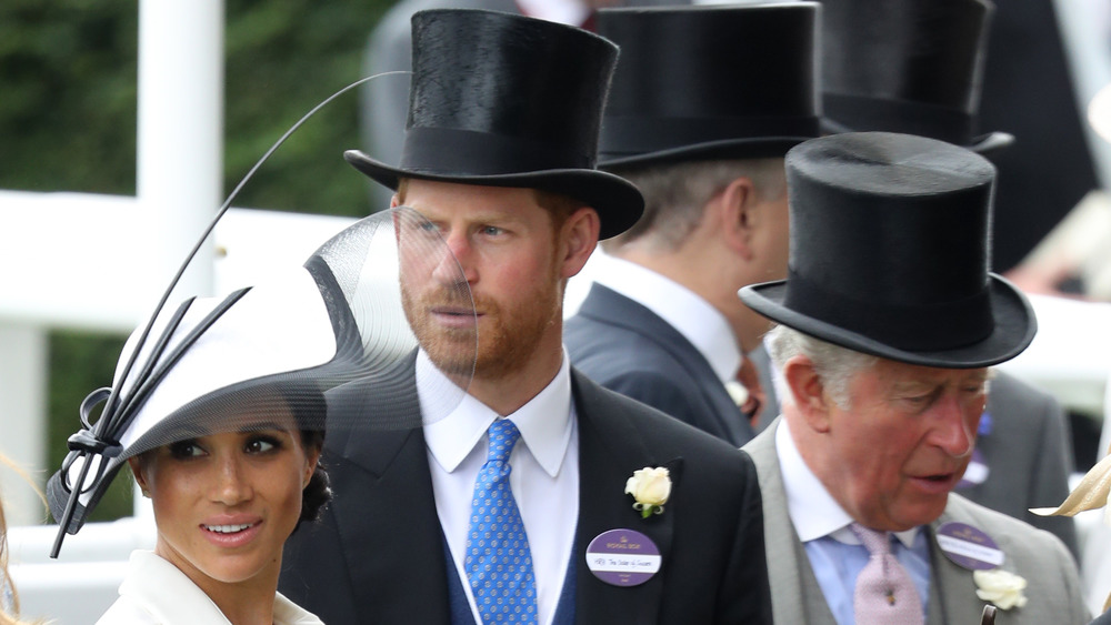 Meghan Markle, Prince Harry, and Prince Charles looking serous