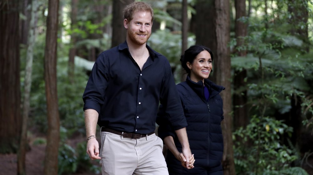 Prince Harry and Meghan Markle walking in the woods