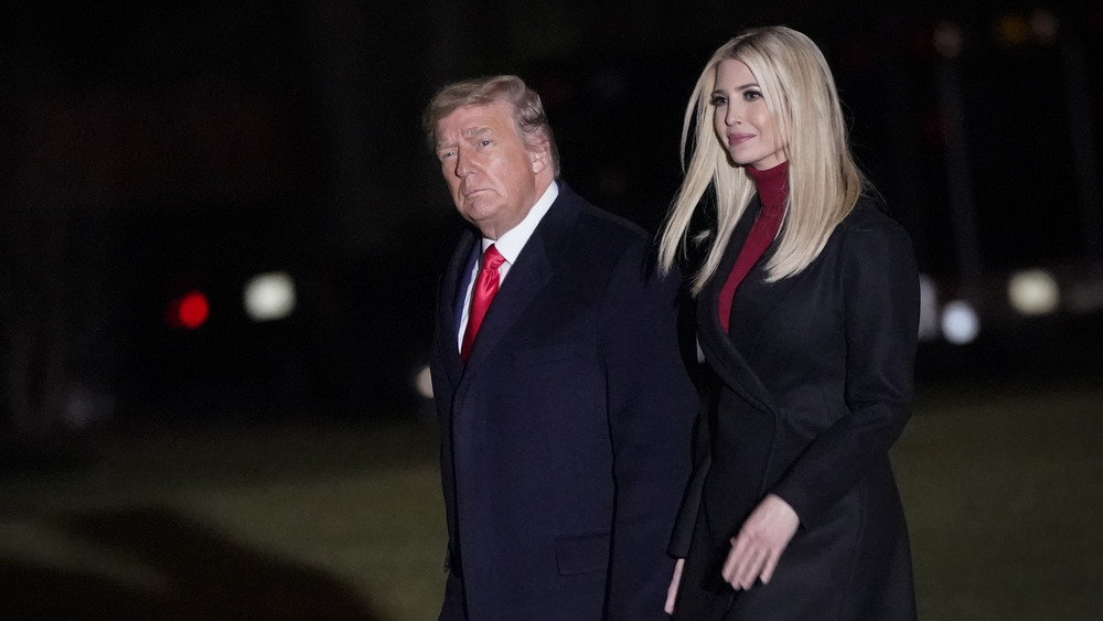 Ivanka Trump and Donald Trump walking at night