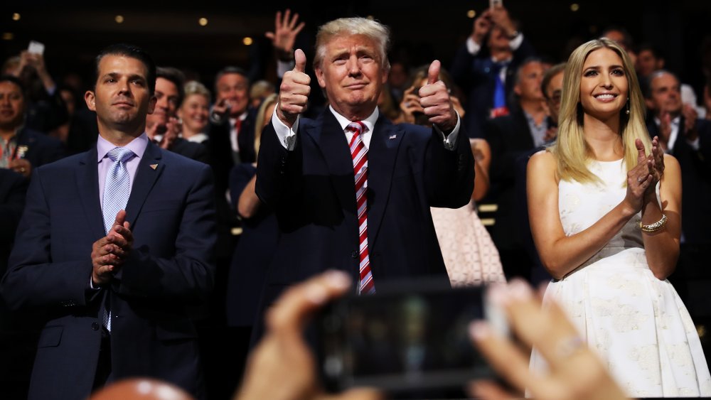 Donald Trump Jr., Donald Trump, and Ivanka Trump clapping in a crowd