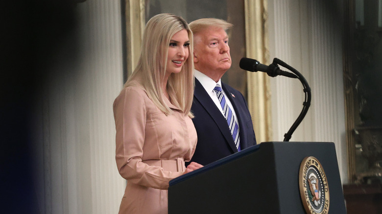Ivanka Trump speaking at the White House while Donald Trump looks out