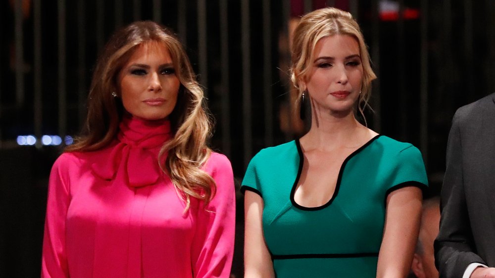 Melania Trump in a pink dress, Ivanka Trump in a teal dress, both with small smiles