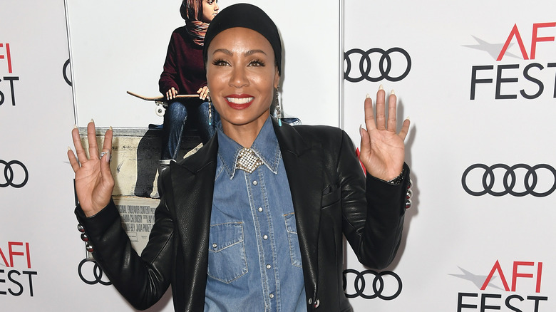 Jada Pinkett Smith, smiling, waving her hands up, 2019 red carpet