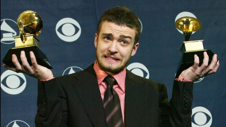 Justin Timberlake holding Grammy awards