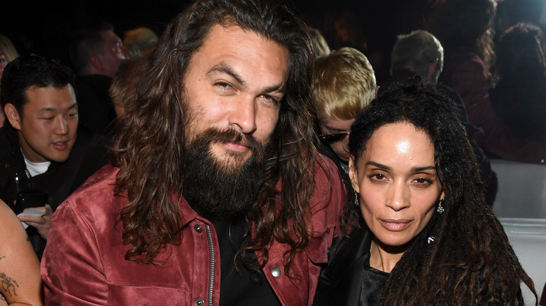 Jason Momoa and Lisa Bonet, both smirking