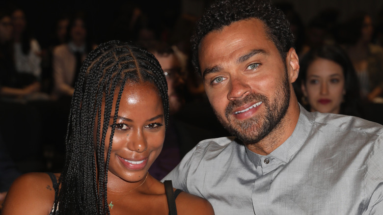 Taylour Paige and Jesse Williams sitting at an event together 