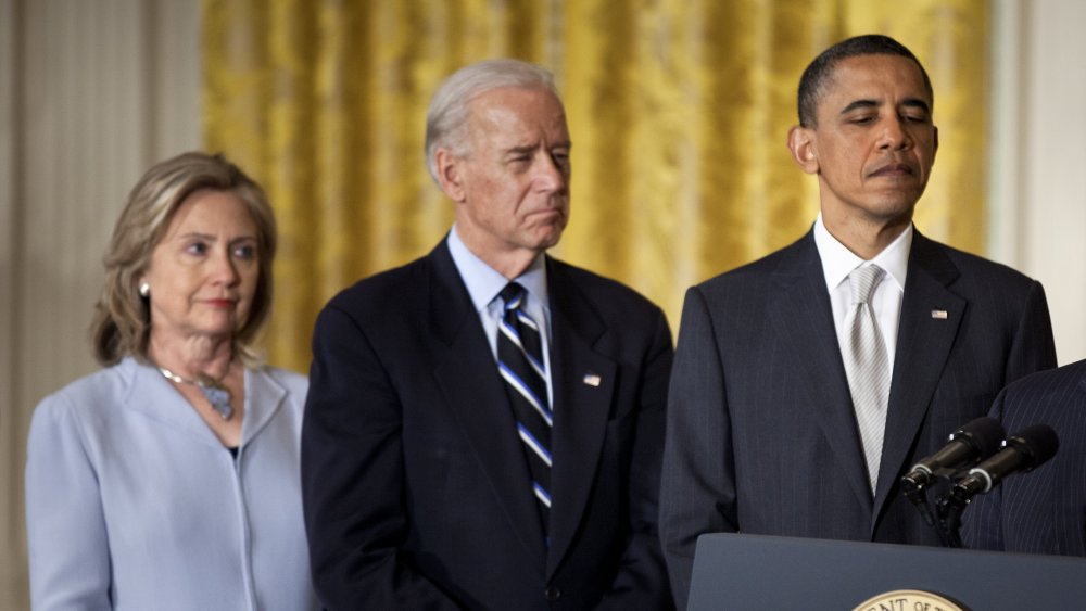 Hillary Clinton and Joe Biden stand behind Barack Obama 