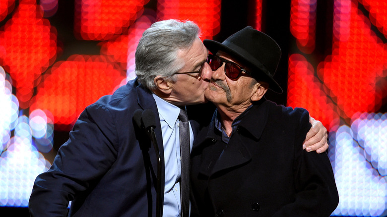 Robert De Niro kisses Joe Pesci on the cheek
