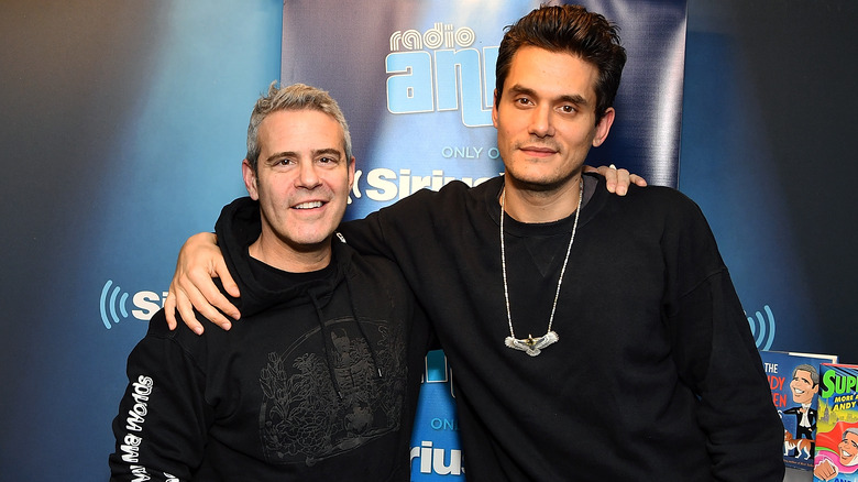 John Mayer and Andy Cohen arms around each other