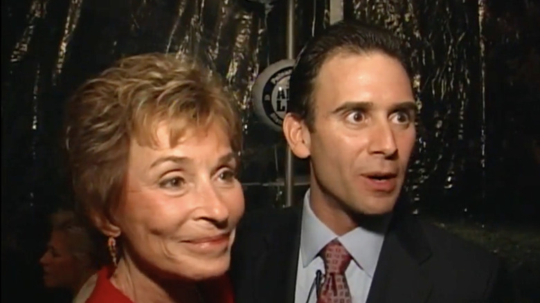 Judge Judy at a party with Adam Levy, smiling