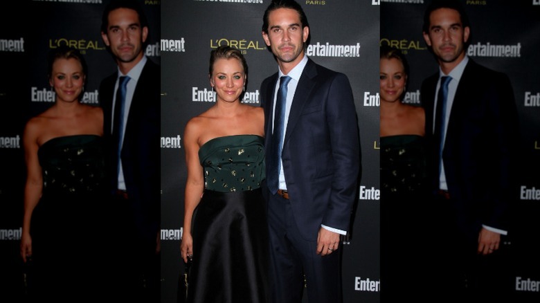 Kaley Cuoco smiling beside Ryan Sweeting at an event